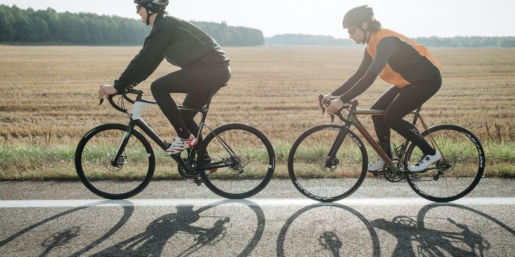 Two people biking on the road