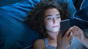 Woman using phone before sleeping Woman using phone before sleeping