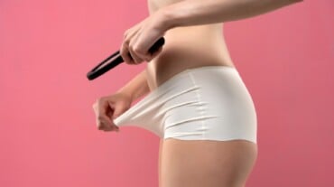 A woman looking at her vagina. A woman looking at her vagina.
